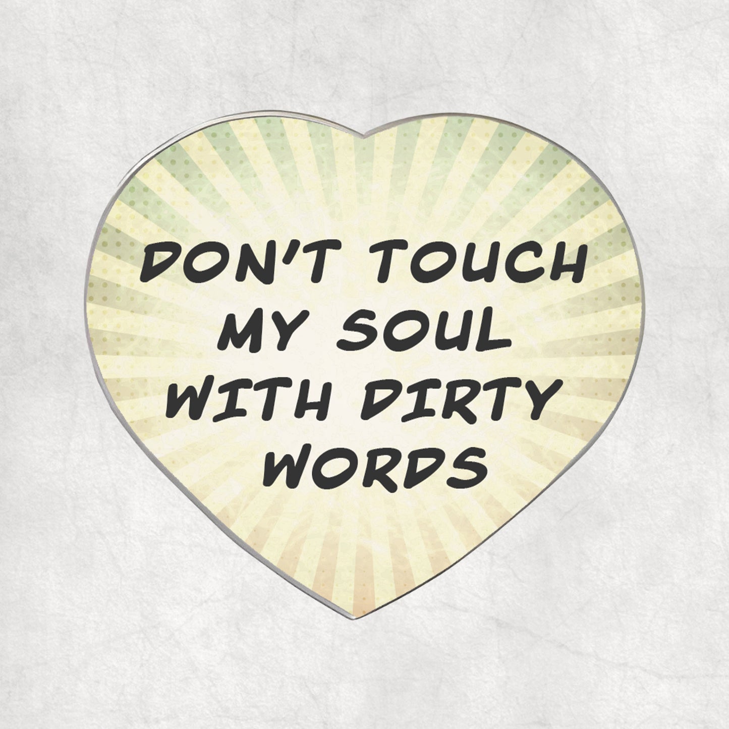 Heart-shaped metal magnet with 'Don't touch my soul with dirty words' text, on a light vintage background.