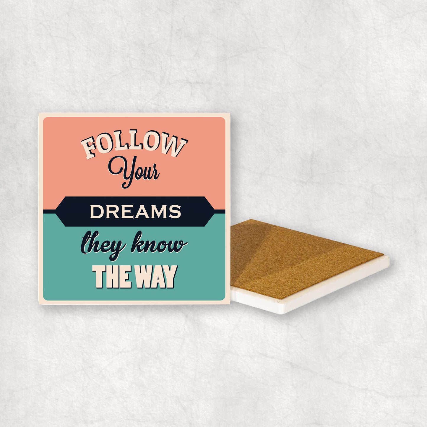 Inspiring ceramic coaster with 'Follow your dreams they know the way' text, perfect gift for any occasion.