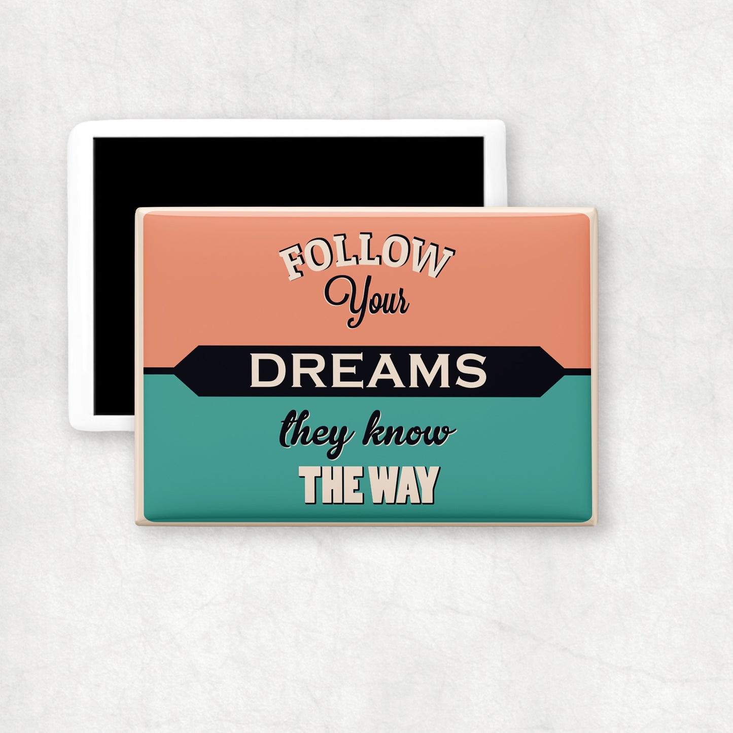 A horizontal ceramic magnet with 'FOLLOW YOUR DREAMS THEY KNOW THE WAY' text design on a vintage background, a perfect gift for any ocasion.