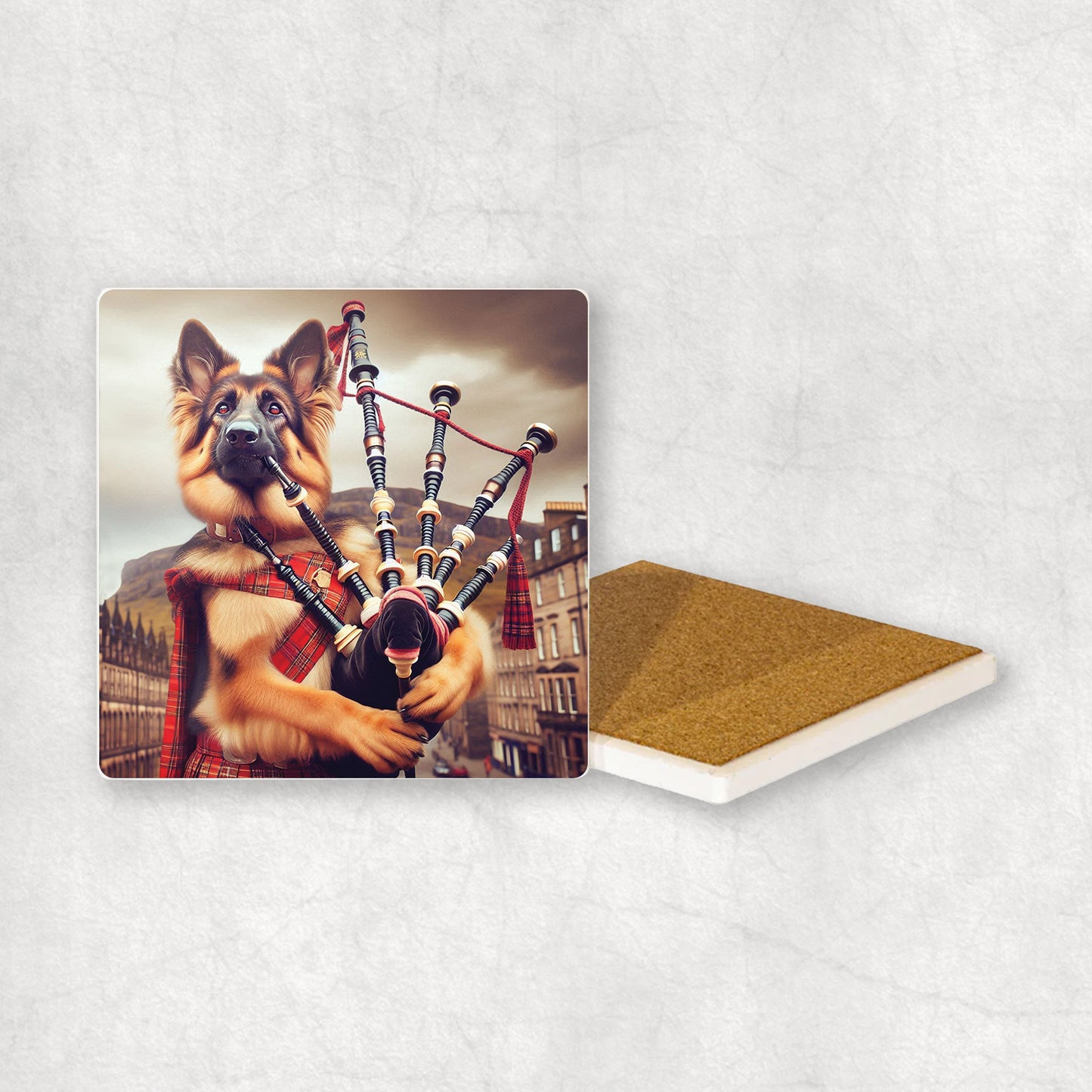 Ceramic Coaster gift with a German Shepherd dog design, dressed in traditional Scottish costume, playing the bagpipes, with Edinburgh in the background.