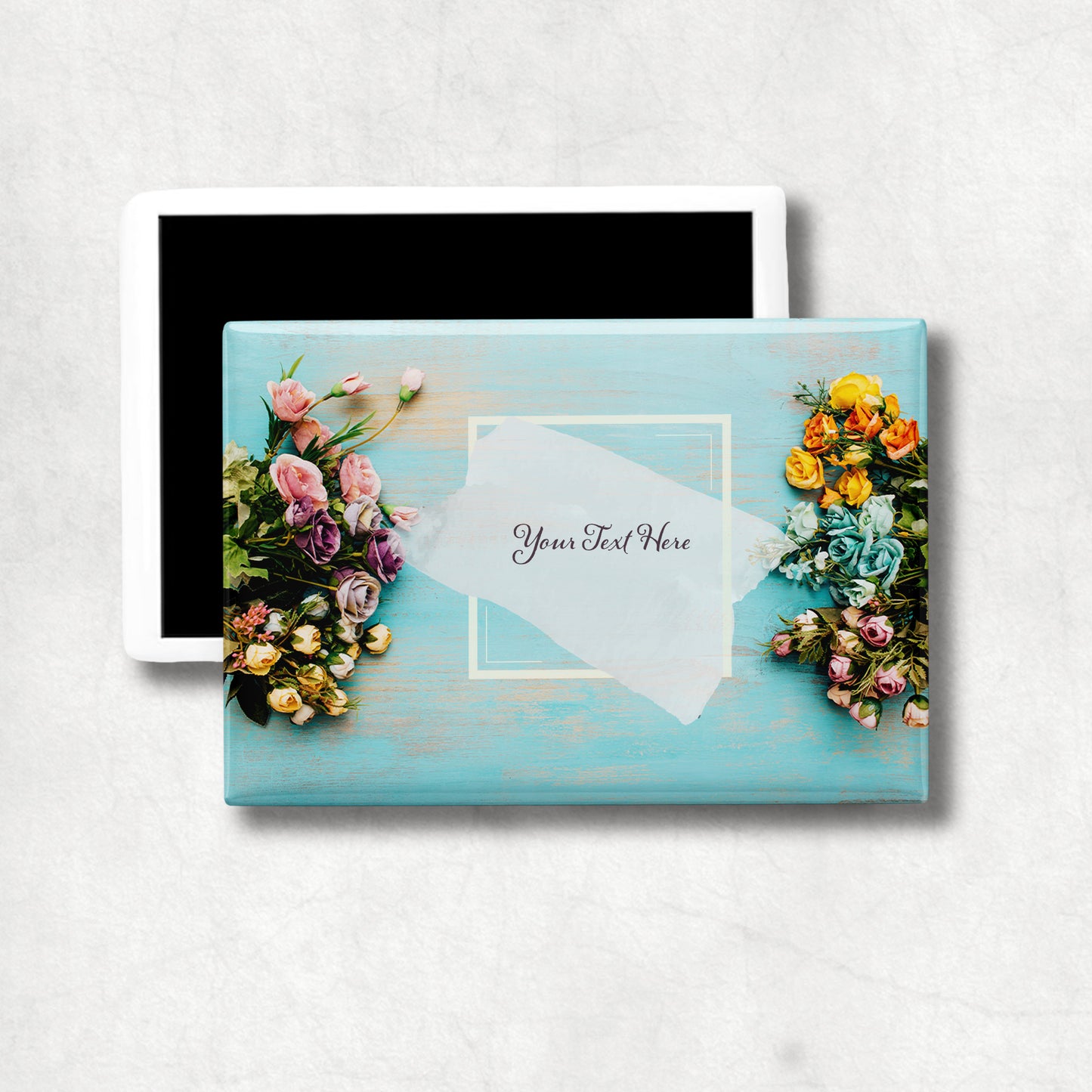 Horizontal ceramic magnet with floral design and customizable text area on a light blue background.