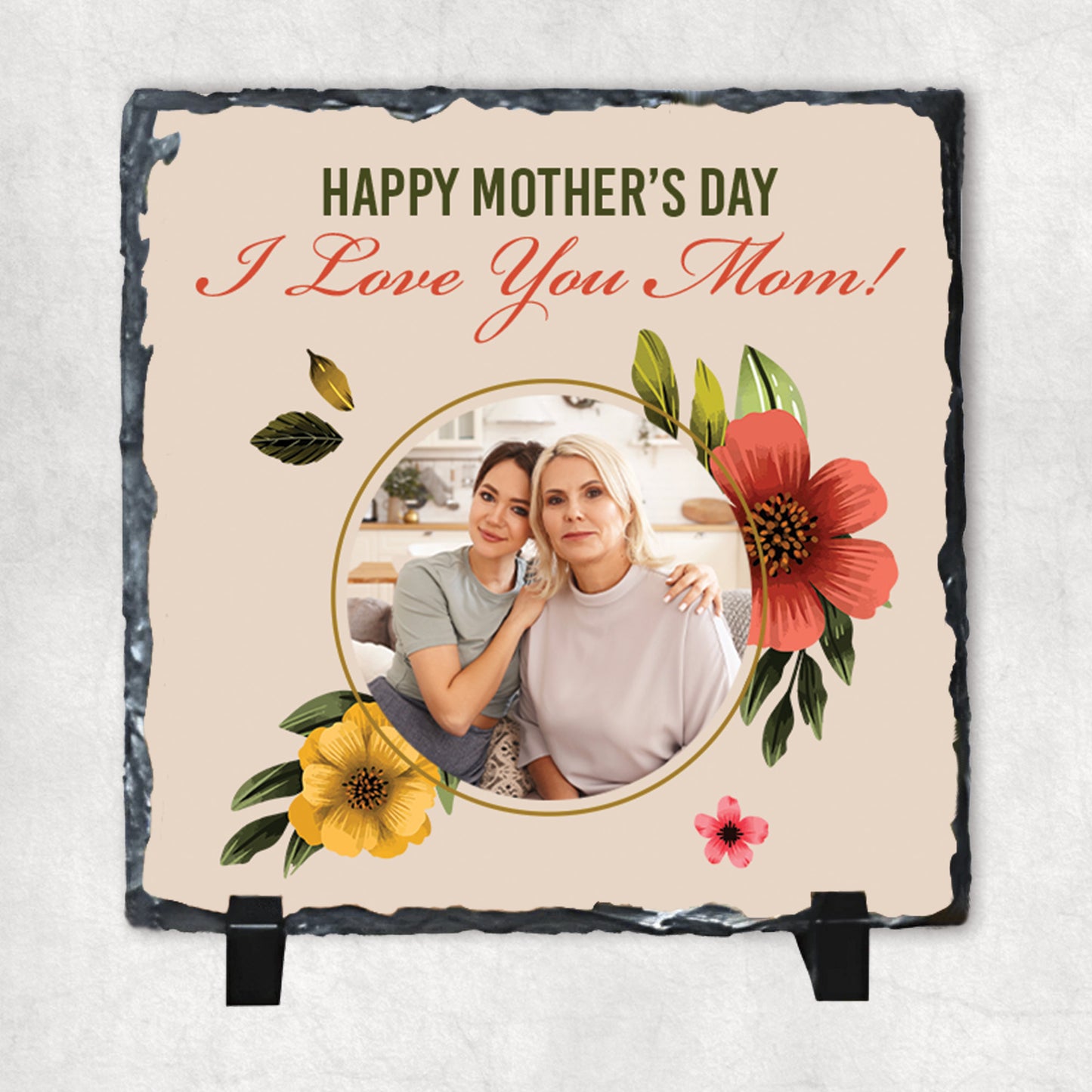 A personalized photo print on a rock slate with flowers, featuring text 'Happy Mother's Day I Love You Mom!', surrounded by decorative flowers.