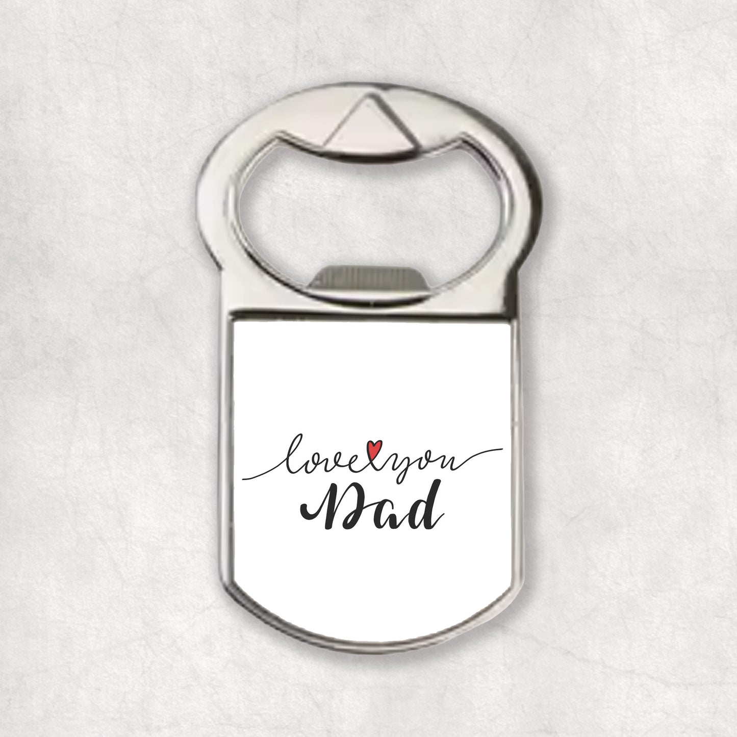 A silver bottle opener magnet with the 'Love you Dad' print and heart symbol on the front.