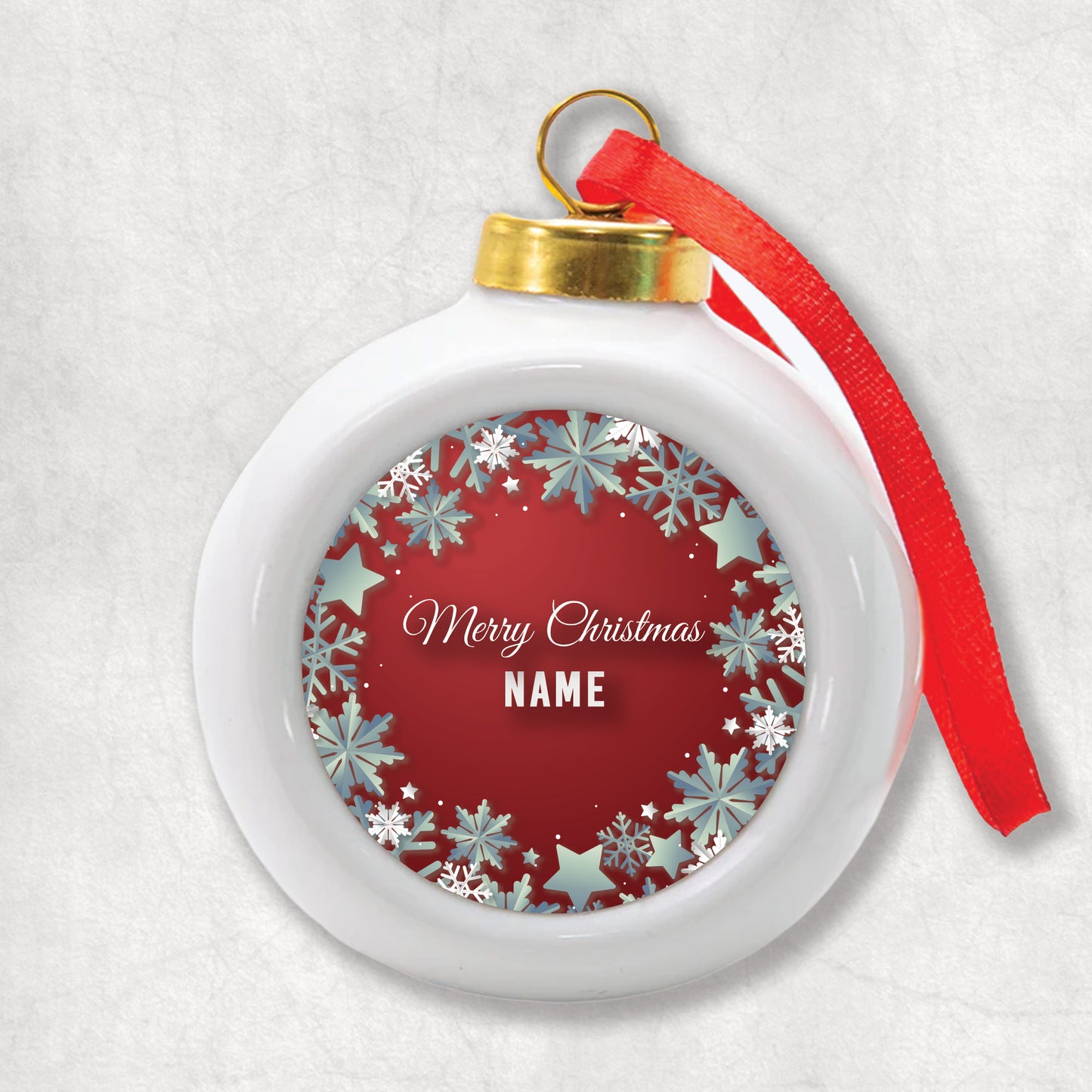 3D Ceramic Christmas bauble with personalised name print and 'Merry Christmas' text with silver snowflakes on a red background.