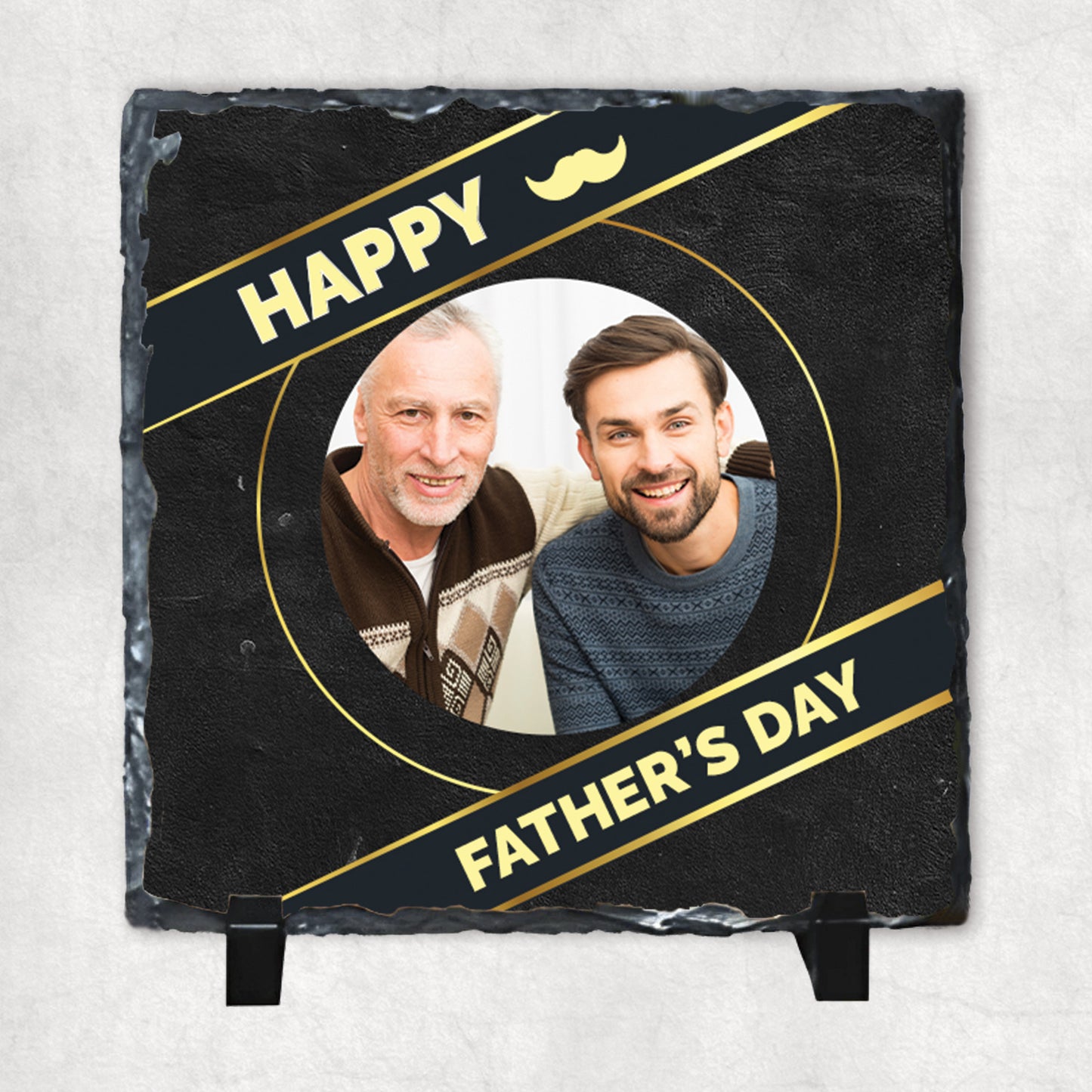 A personalised photo rock slate with a circular photo print, and the text 'Happy Father's Day'. The slate has a glossy finish with gold decorative elements.