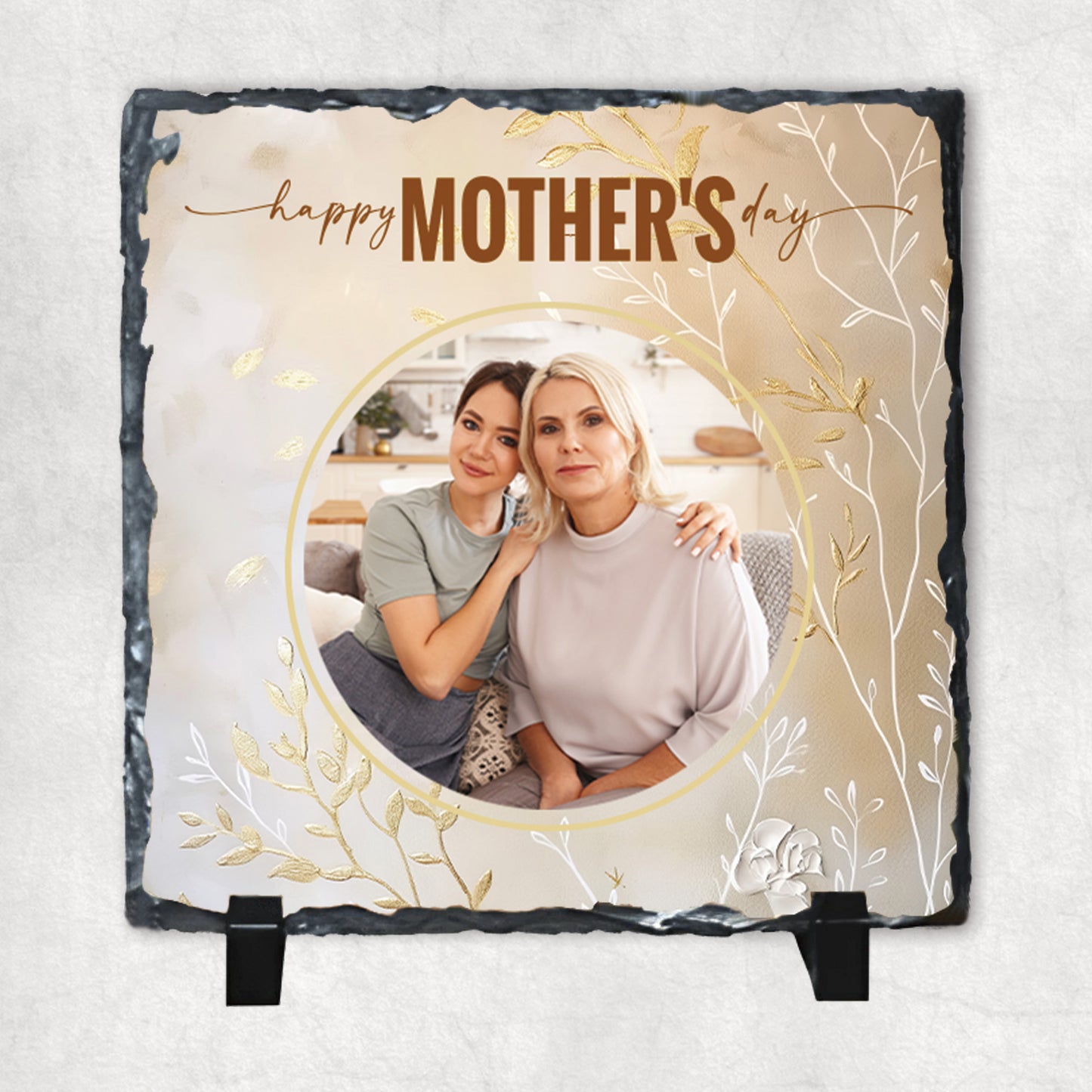 A personalized photo rock slate with a circular personalised photo print, and gold text 'Happy Mother's Day'.