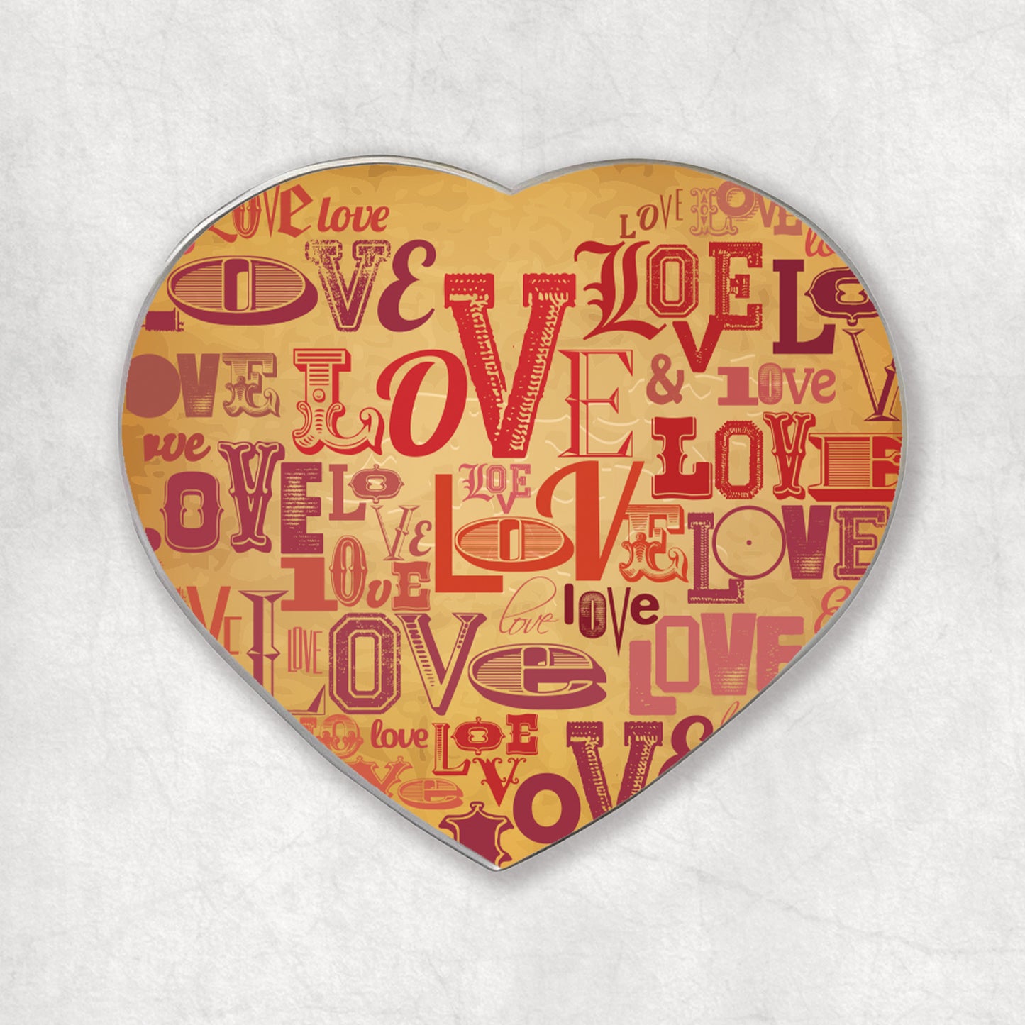 A heart-shaped magnet with the word 'love' printed in vintage style.