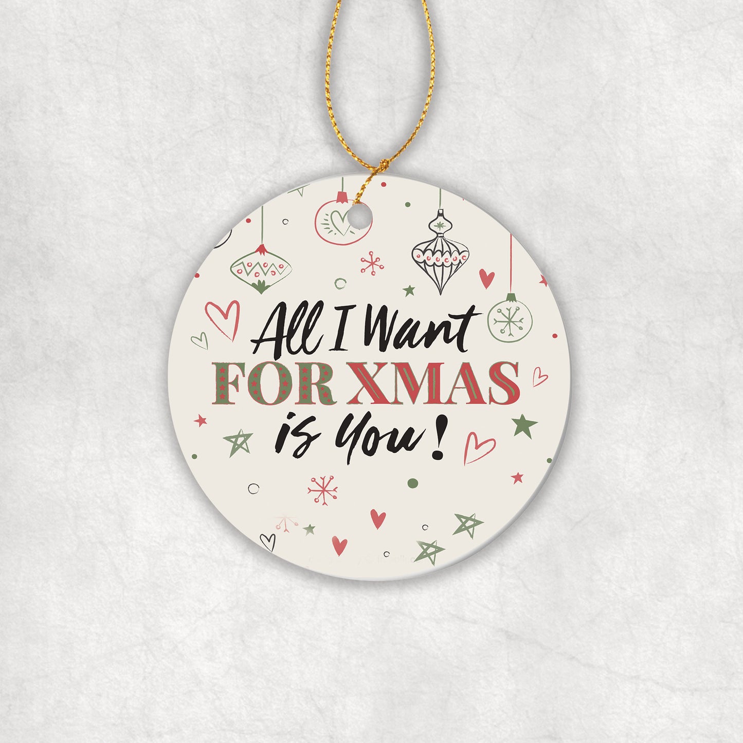 Ceramic Christmas tree round ornament with decorative text 'All I want for Christmas is you' on a white background.