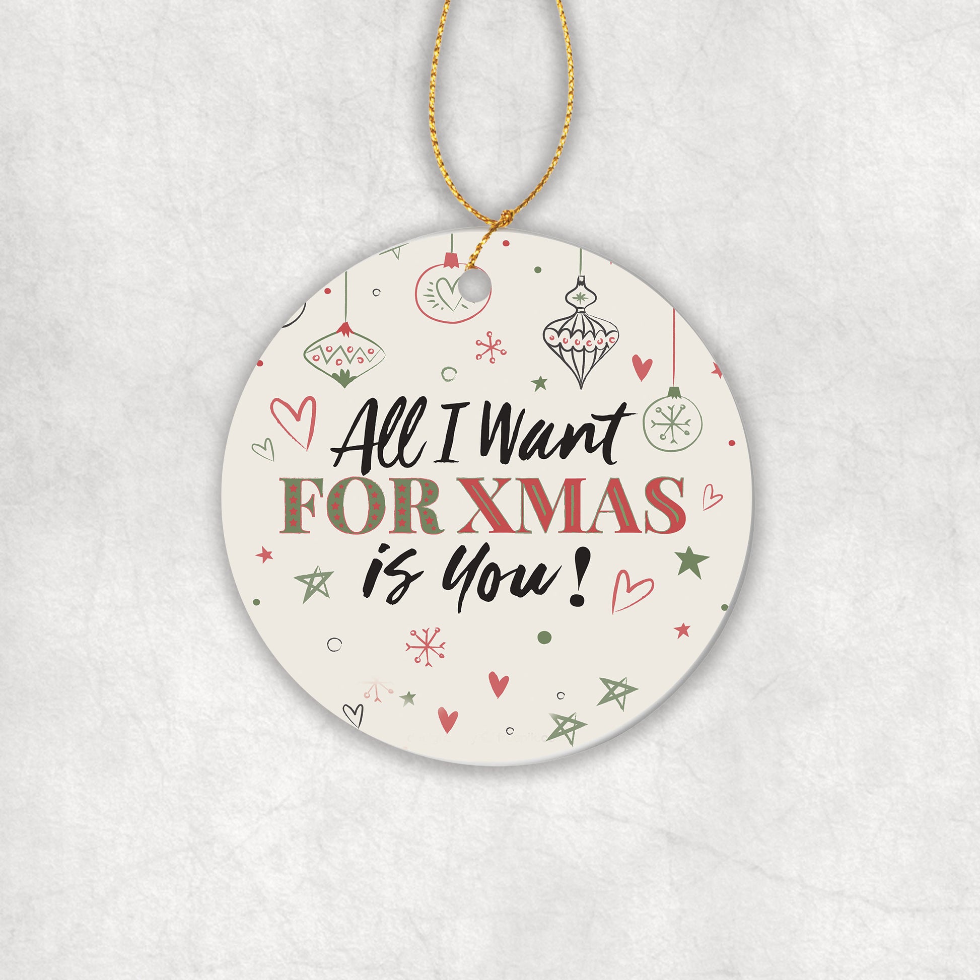 Ceramic Christmas tree round ornament with decorative text 'All I want for Christmas is you' on a white background.