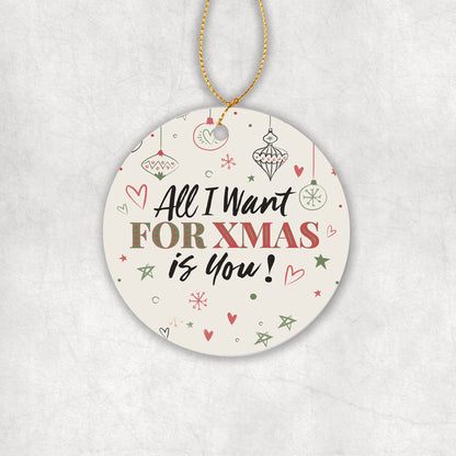 Ceramic Christmas tree round ornament with decorative text 'All I want for Christmas is you' on a white background.