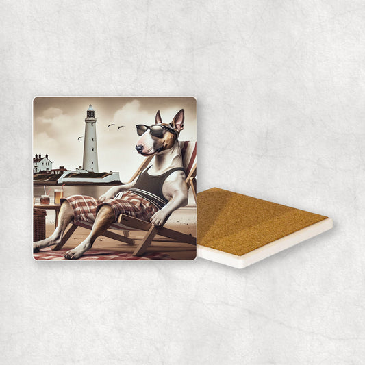 Ceramic Coaster gift with a Bull Terrier dog design, wearing shorts, relaxes on a beach lounger at Whitley Bay with a lighthouse in the background.
