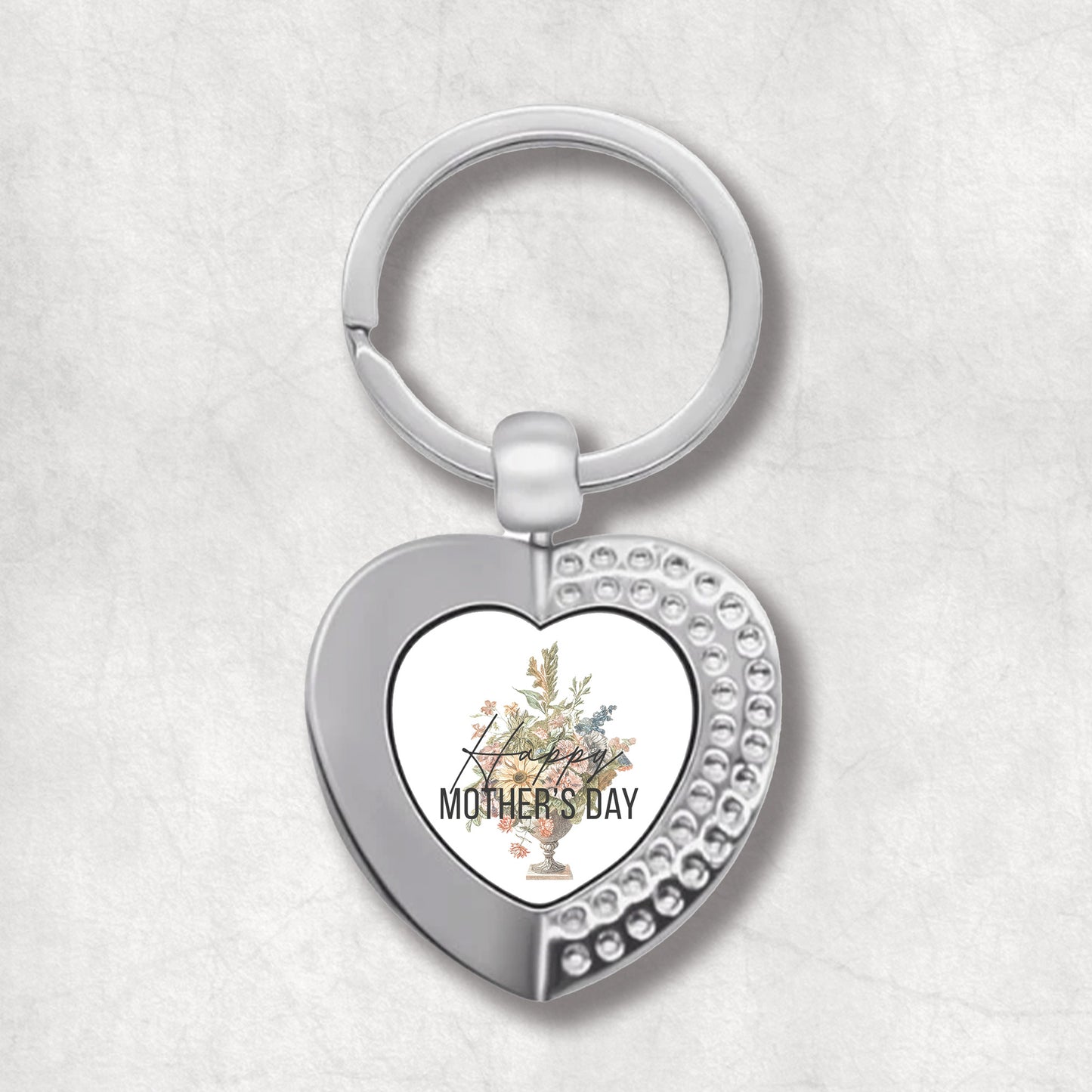 An elegant heart-shaped keyring with a floral design and the text 'Happy MOTHER'S DAY' on it.