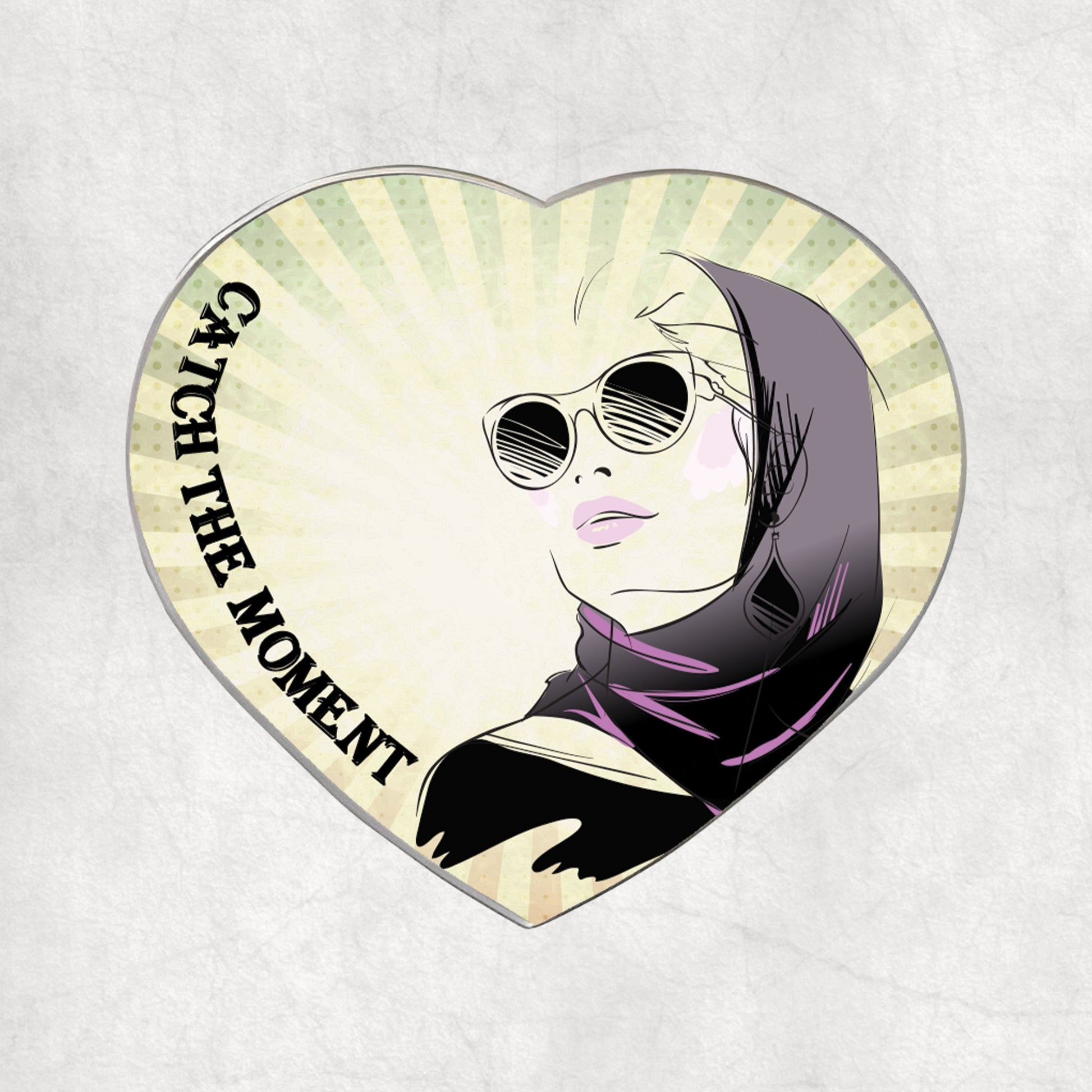 Heart-shaped metal magnet with a woman wearing sunglasses and a hijab design, and 'Catch the Moment' text on a light vintage background.