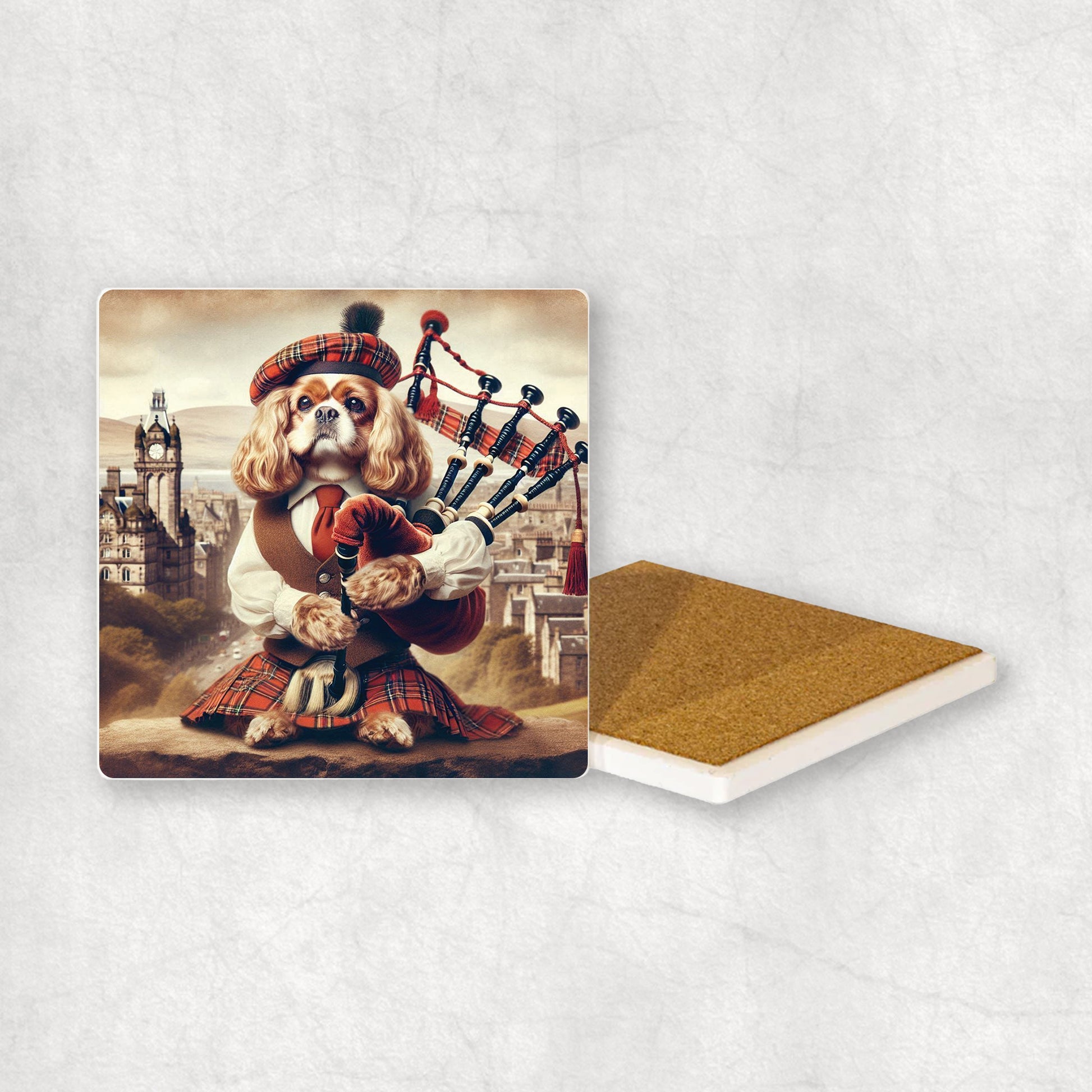 Ceramic Coaster gift with a Cavalier dog design, dressed in traditional Scottish costume, playing the bagpipes, with Edinburgh in the background. 