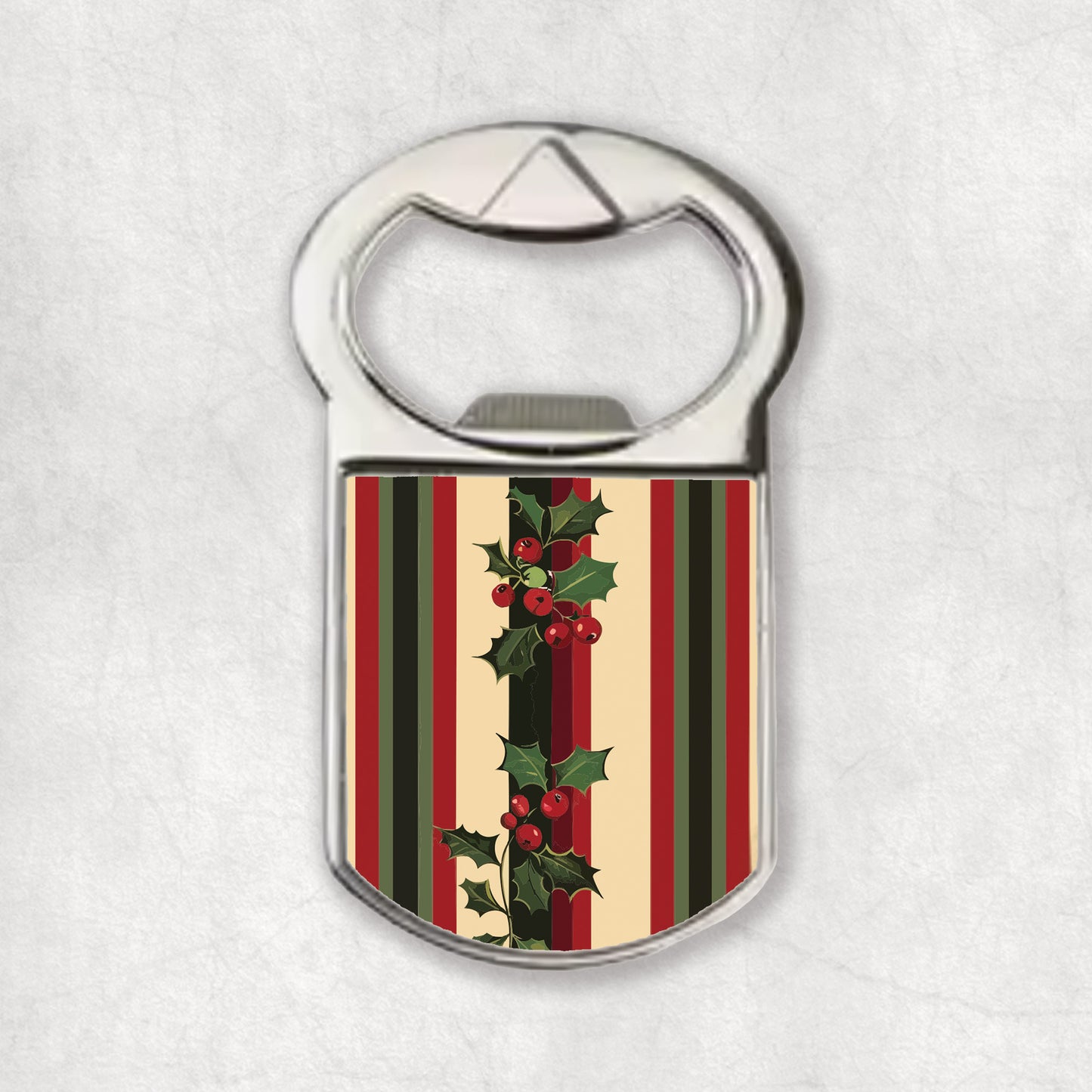 Bottle opener magnet with striped design and holly leaves on a white background.