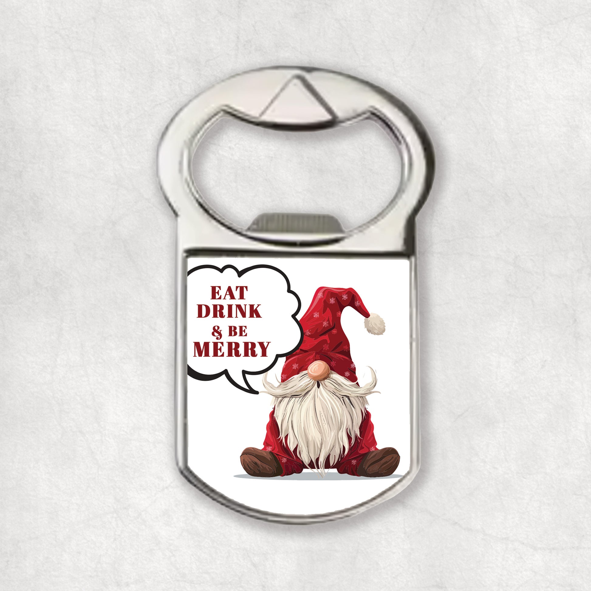 Bottle opener magnet with red Christmas gnome and the 'Eat, drink & Be Merry' text.