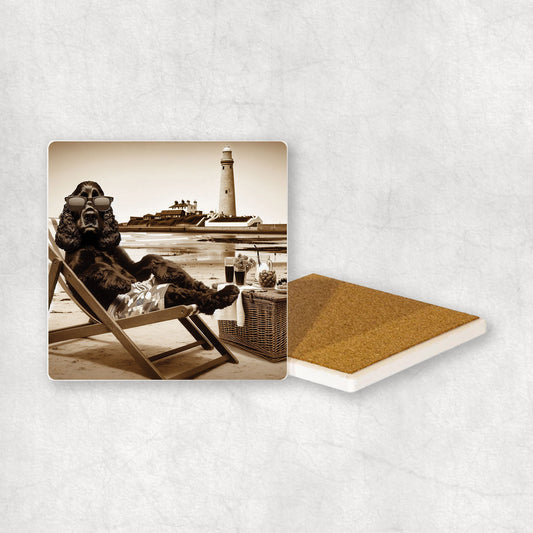 Ceramic Coaster gift with a Cocker Spaniel dog design, wearing shorts, relaxes on a beach lounger at Whitley Bay with a lighthouse in the background.