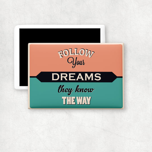 A horizontal ceramic magnet with 'FOLLOW YOUR DREAMS THEY KNOW THE WAY' text design on a vintage background, a perfect gift for any ocasion.