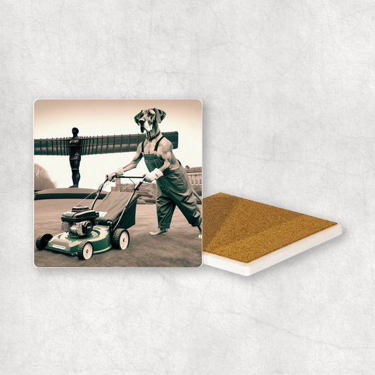 Ceramic coaster with a Great Dane dog design, dressed as a gardener, mowing the grass with a lawnmower, with the Angel of the North in the background.