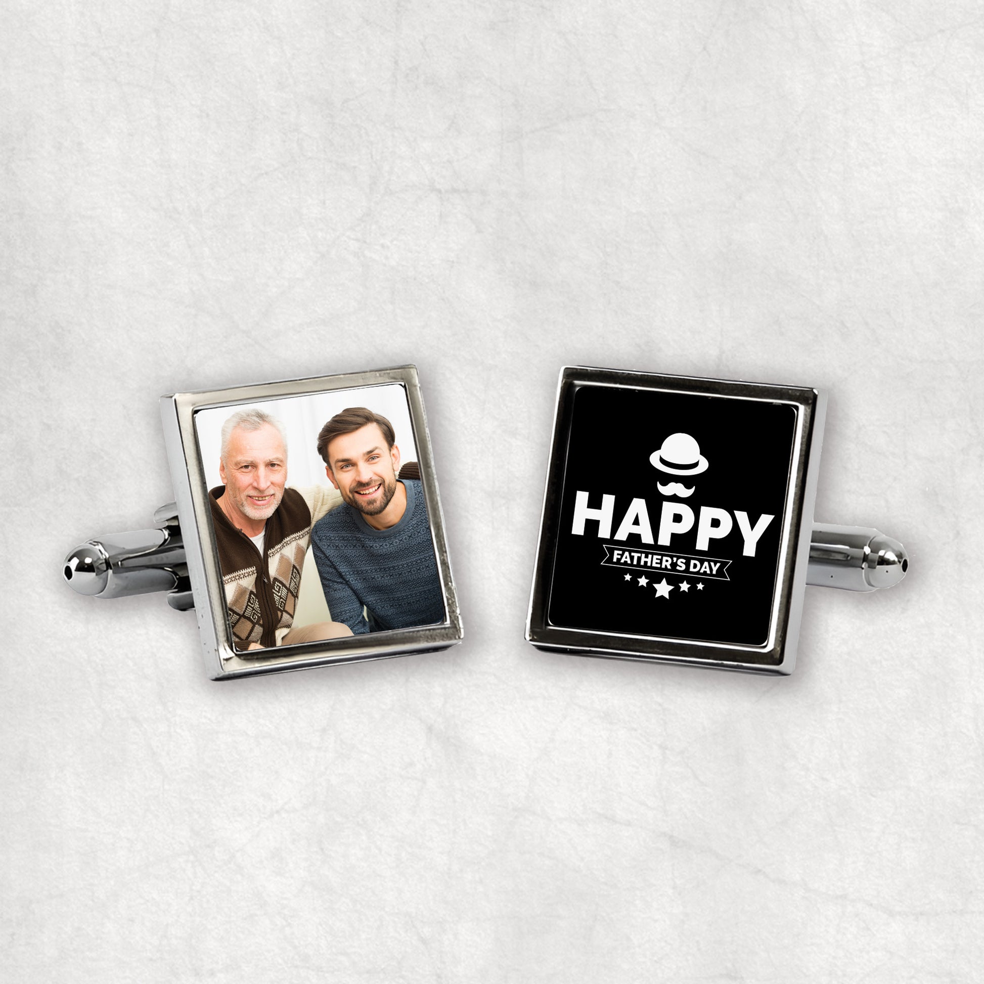 A pair of personalised silver cufflinks with one featuring a personalised photo and the other displaying a 'Happy Father's Day' text, both presented on a white background.