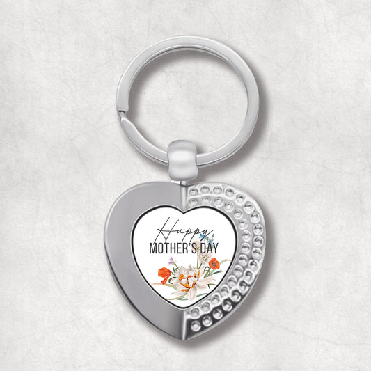 An elegant heart-shaped keyring with a printed message 'Happy Mother's Day' surrounded by poppy flowers.