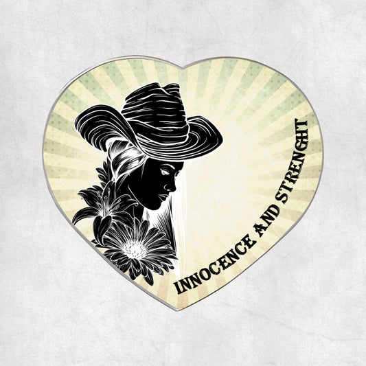 Heart-shaped metal magnet with a silhouette of a woman, flowers, and the text 'Innocence and Strength' on a light vintage background.