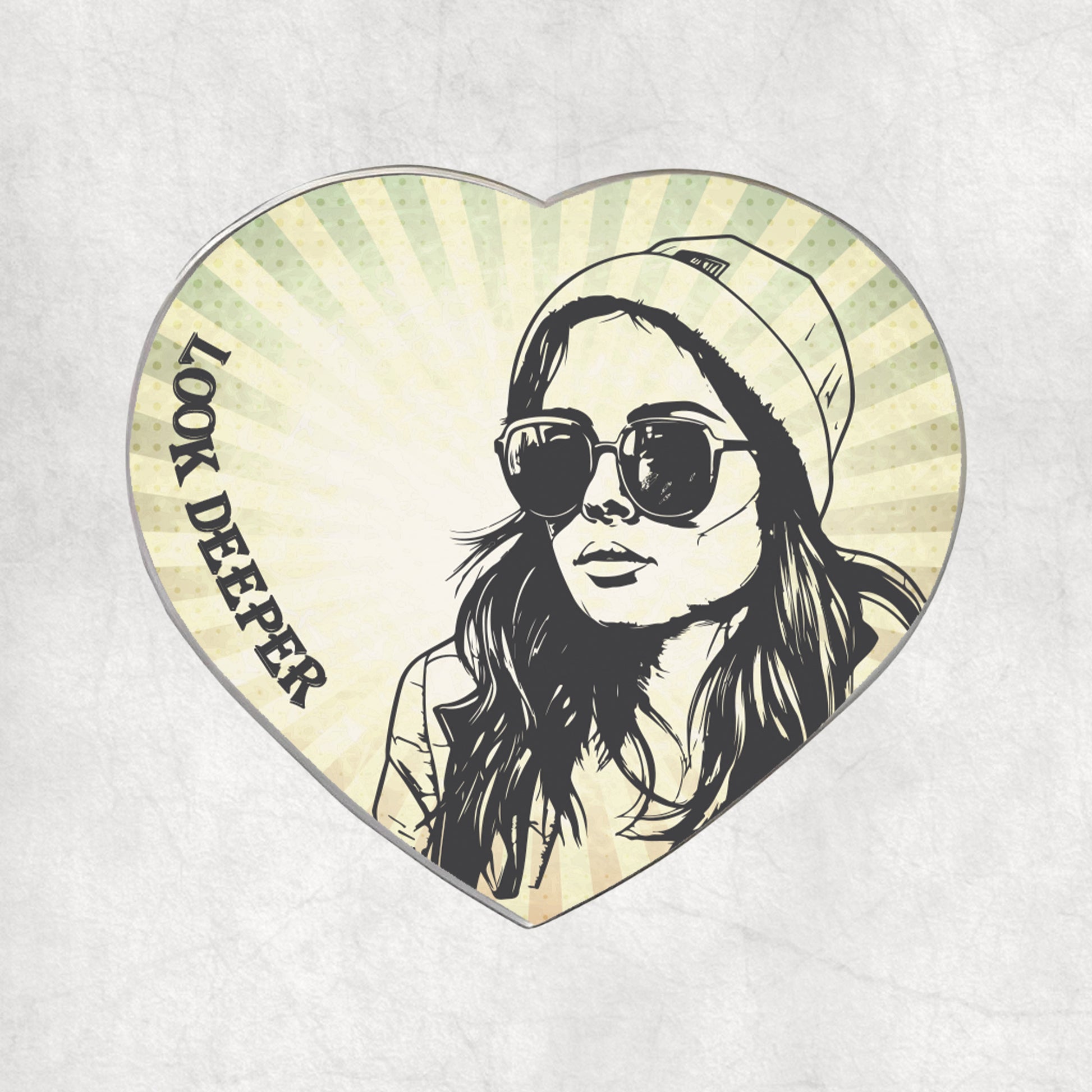 Heart-shaped metal magnet with a stylized portrait of a woman wearing sunglasses and a beanie, with 'Look Deeper' text on the light vintage background.