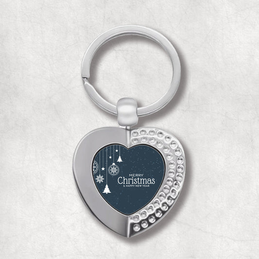 Heart-shaped keyring with Christmas ornaments design and 'Merry Christmas' text on a navy blue snowy background.