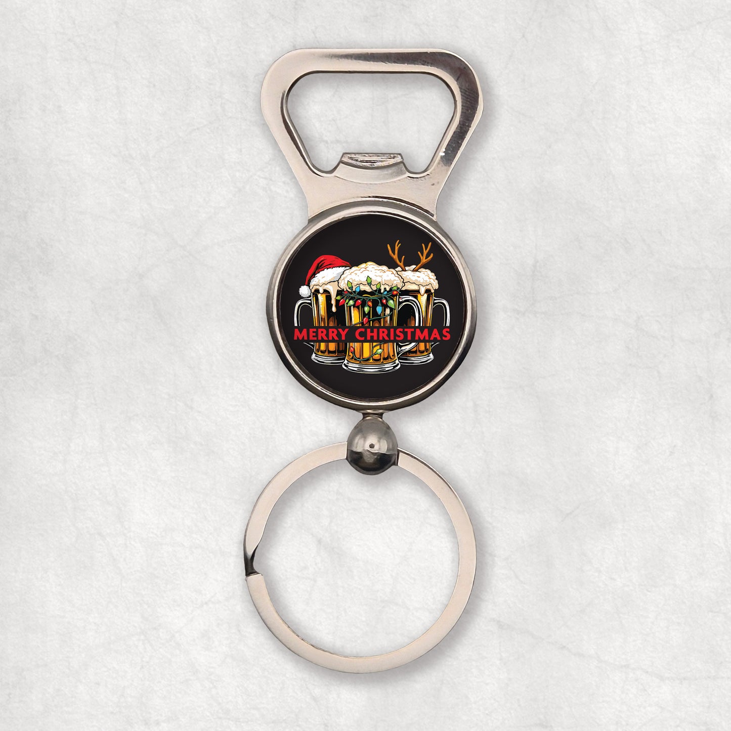 Bottle opener keyring with Christmas design presented tree pints of beer with christmas hat & light on a black background.