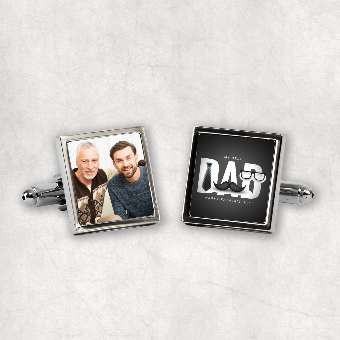 A pair of silver cufflinks with one side featuring a personalsed photo, and the other side displaying the text 'My Best DAD', presented on a white background.
