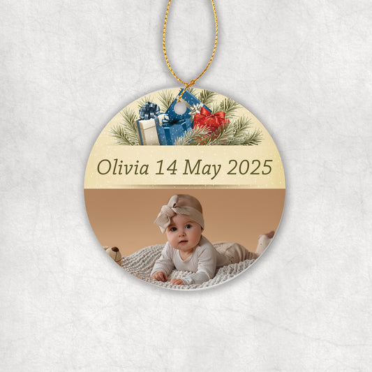 Personalised ceramic round decorative ornament with a baby photo, name, and date on a Christmas background.