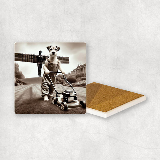 Ceramic coaster with a Parson Russell Terrier dog design, dressed as a gardener, mowing the grass with a lawnmower, with the Angel of the North in the background.