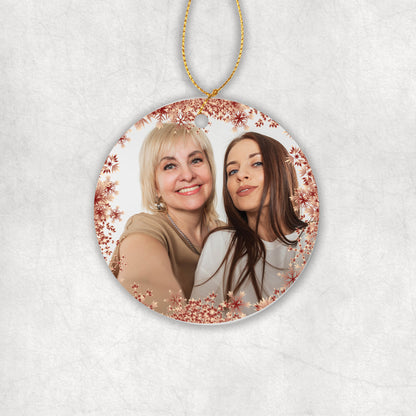 Personalised ceramic Christmas tree round ornament with a photo and red Snowflakes around. 
