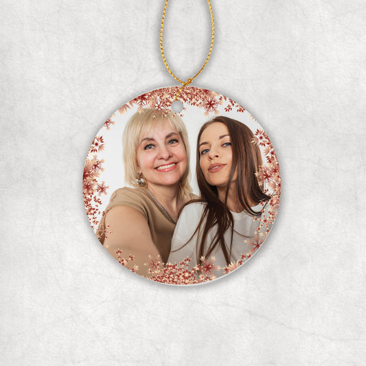 Personalised ceramic Christmas tree round ornament with a photo and red Snowflakes around. 