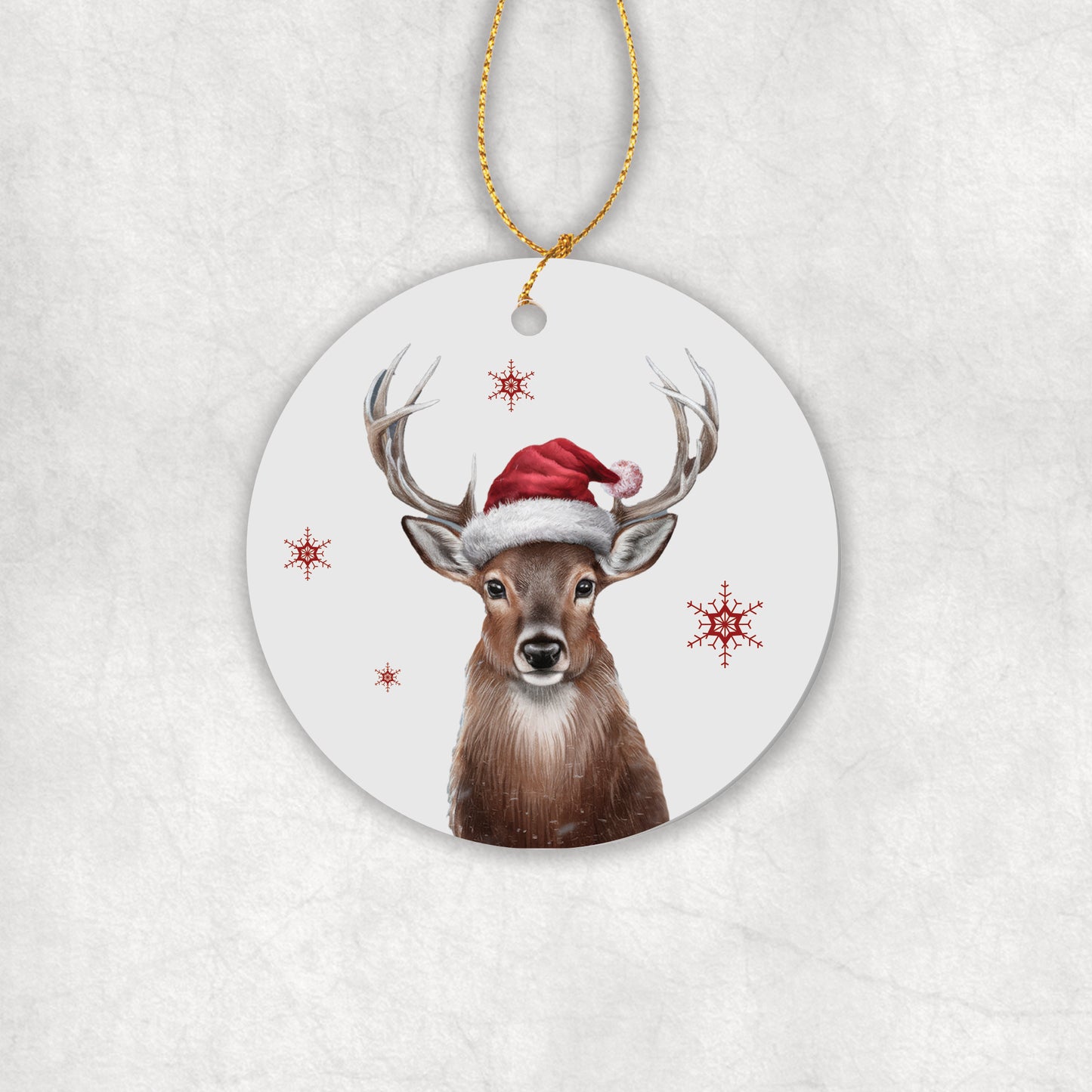 Ceramic round Christmas ornament with a deer wearing a Santa hat on a white background