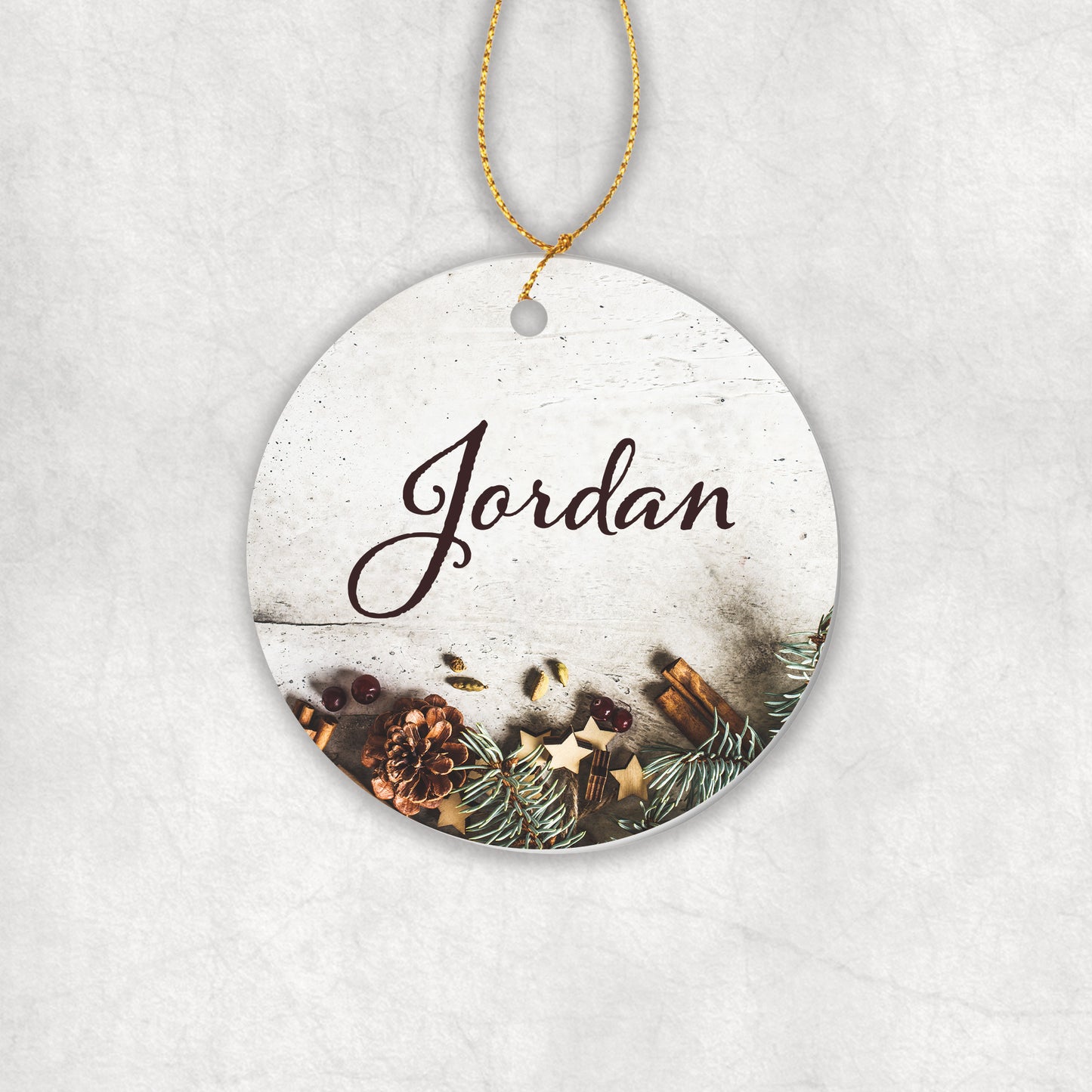 Personalised ceramic round decorative ornament with with your name and Christmas-themed design on a white background