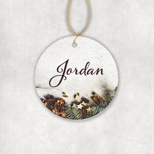 Personalised ceramic round decorative ornament with with your name and Christmas-themed design on a white background