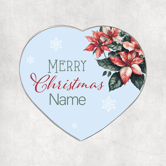 Personalised heart-shaped metal magnet with a ustom name on the festice background. An elegant gift for Christmas. 