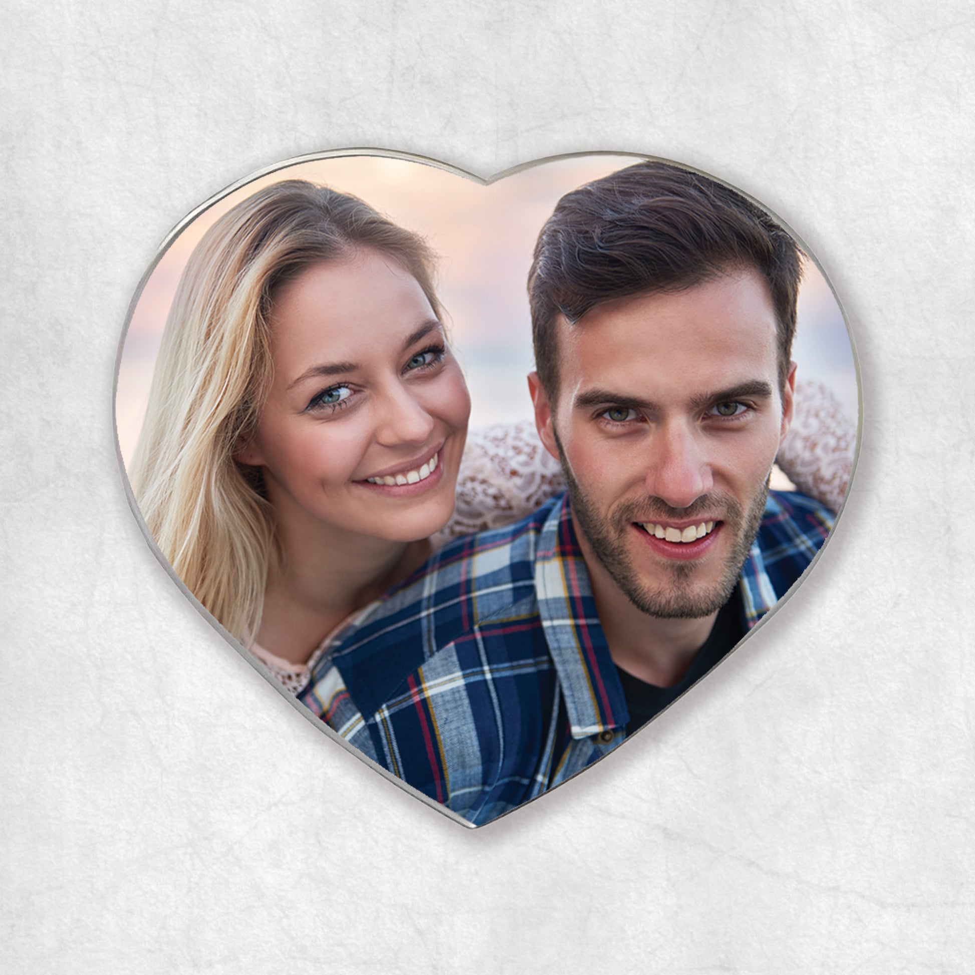 A heart-shaped magnet with a personalised photo printed on it, a perfect gift for any occasion.