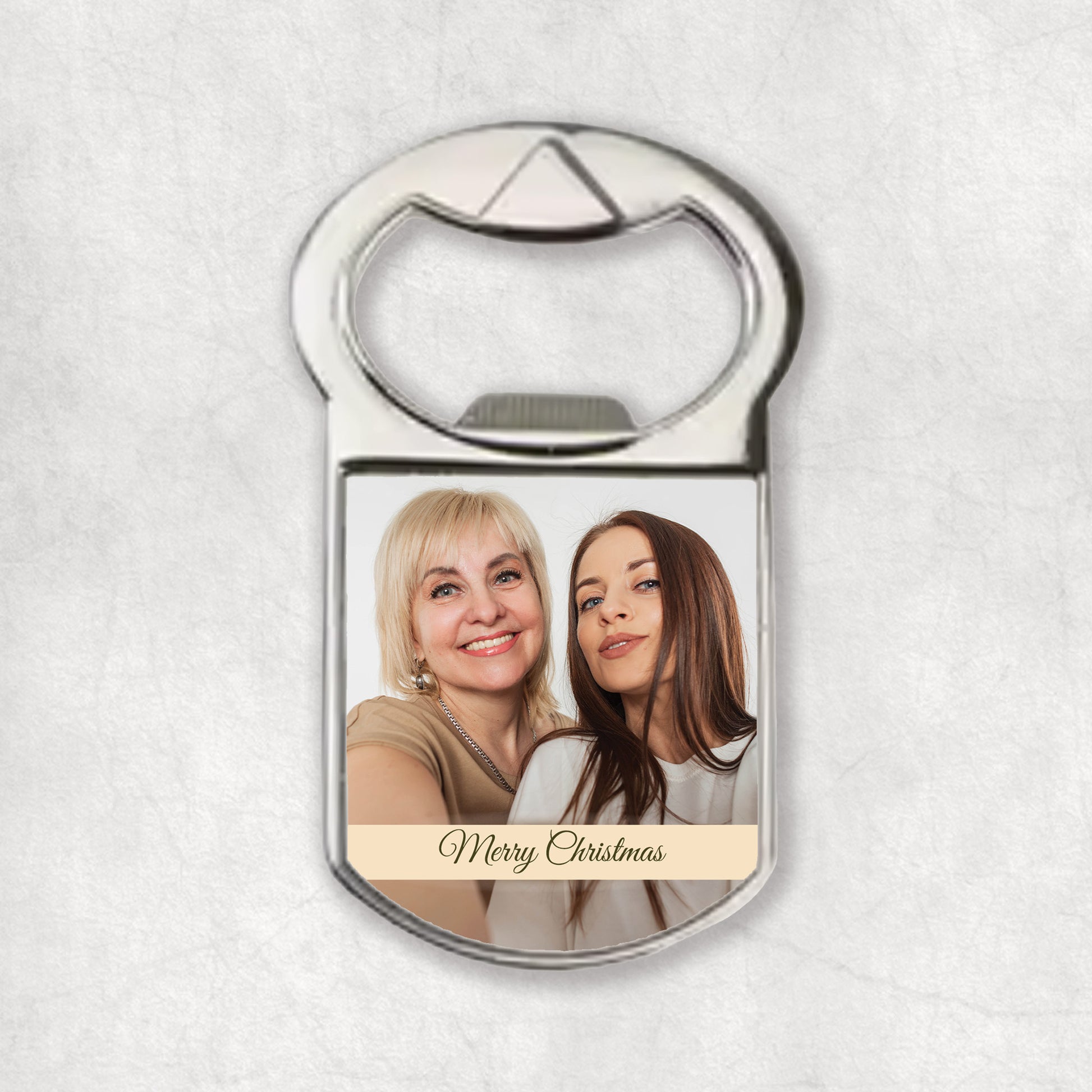 Bottle opener magnet with a and 'Merry Christmas' text on a light gray background.