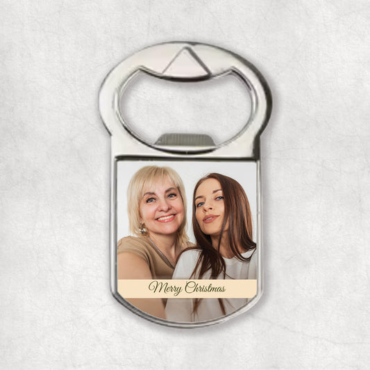 Bottle opener magnet with a and 'Merry Christmas' text on a light gray background.