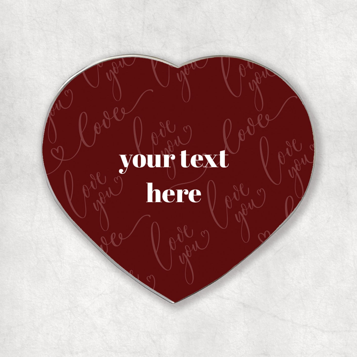 Heart-shaped magnet with 'love you' in a red background and custom white text printed in the middle.