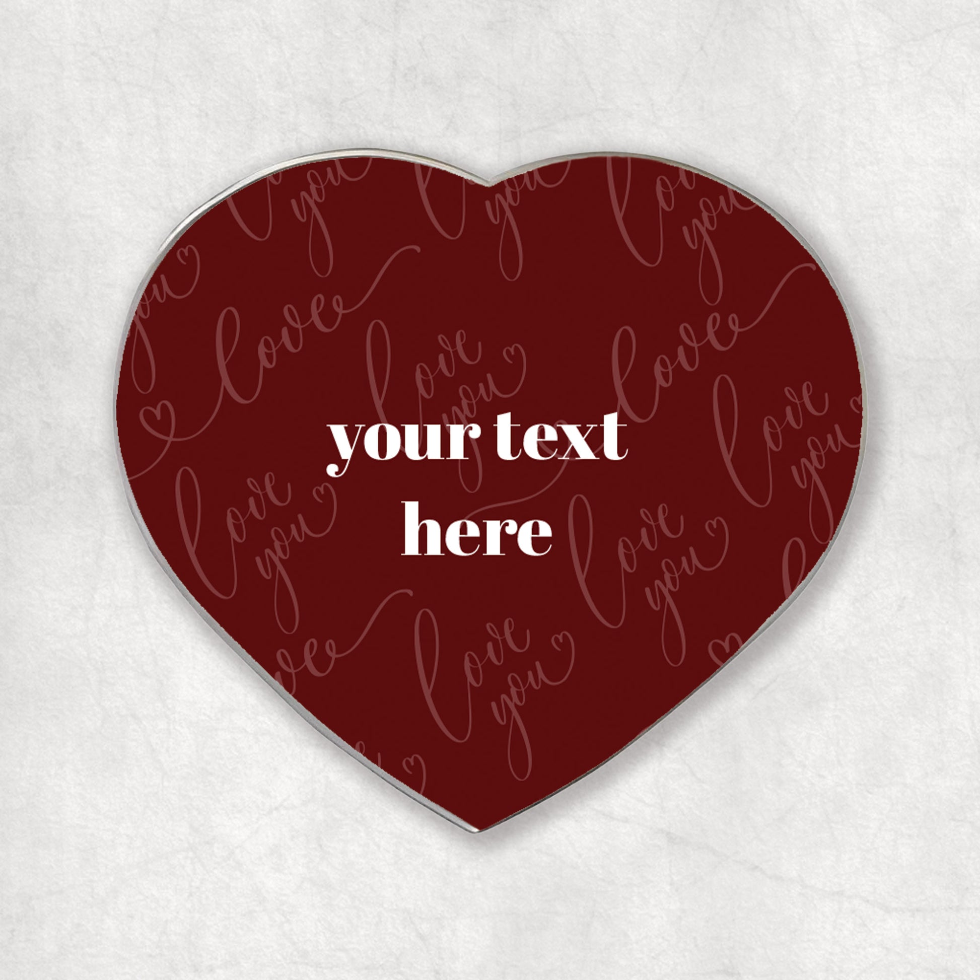 Heart-shaped magnet with 'love you' in a red background and custom white text printed in the middle.