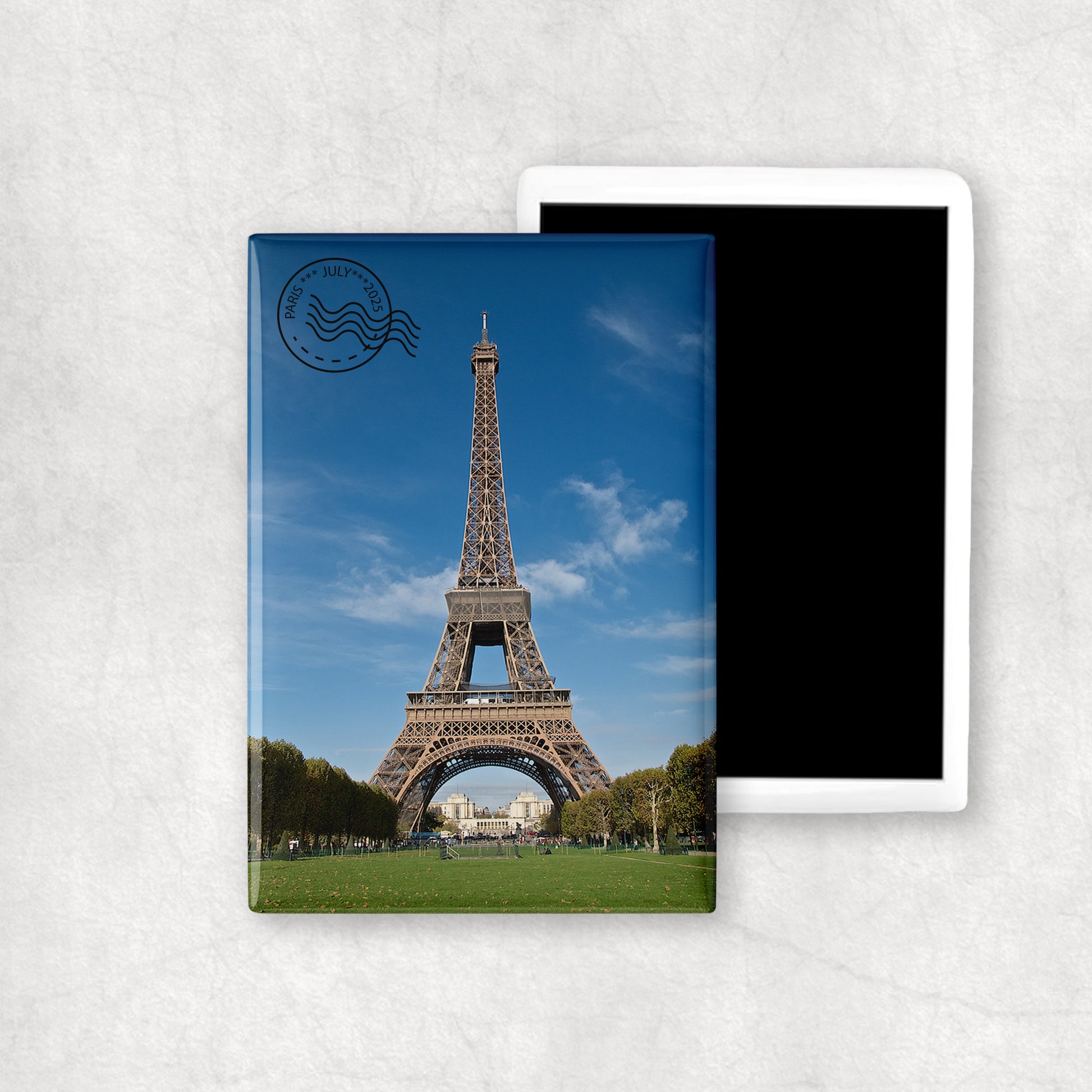 Personalised vertical ceramic magnet with a custom black stamp (with date and location).