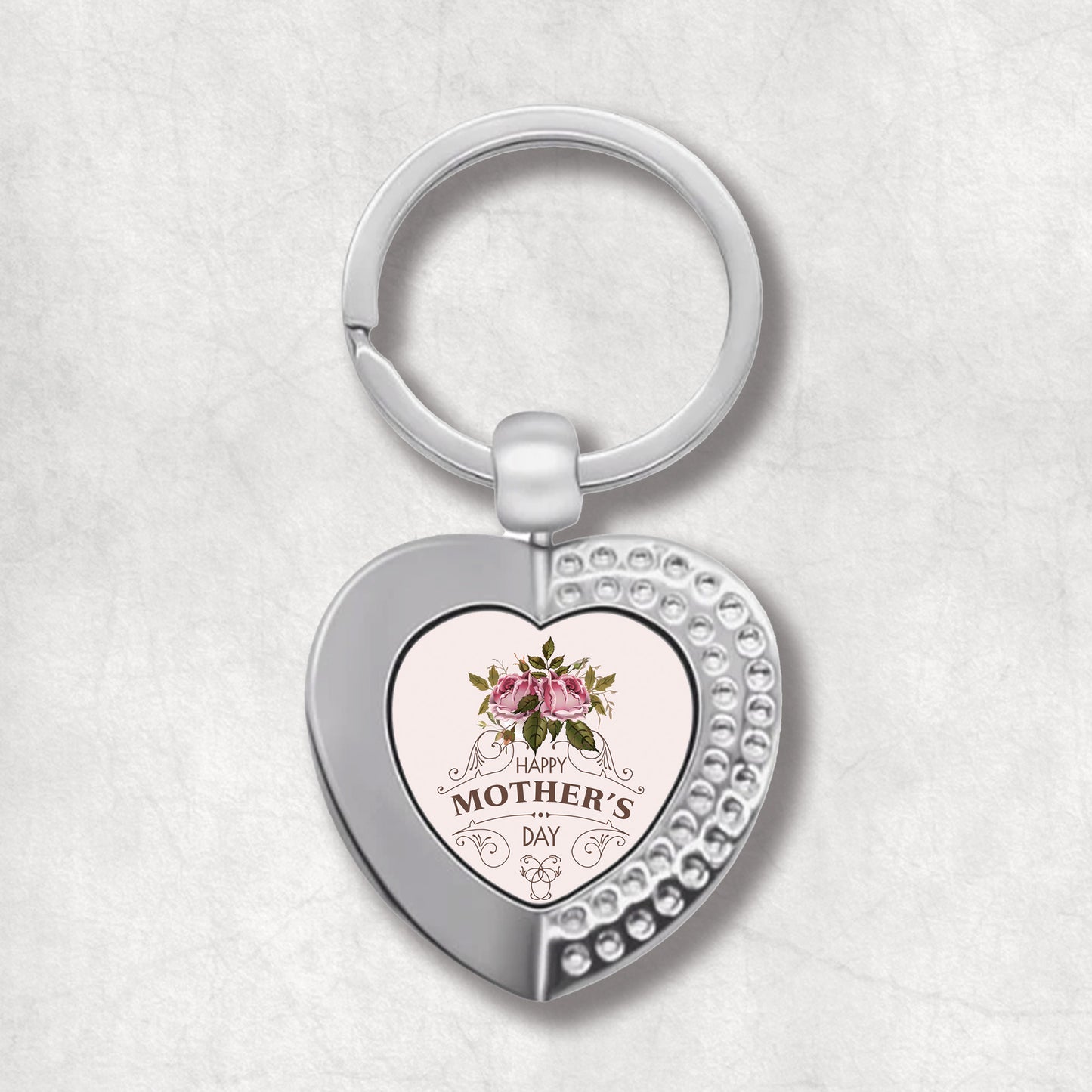 An elegant heart-shaped keyring with a pink rose design and the text 'Happy Mother's Day' on it.