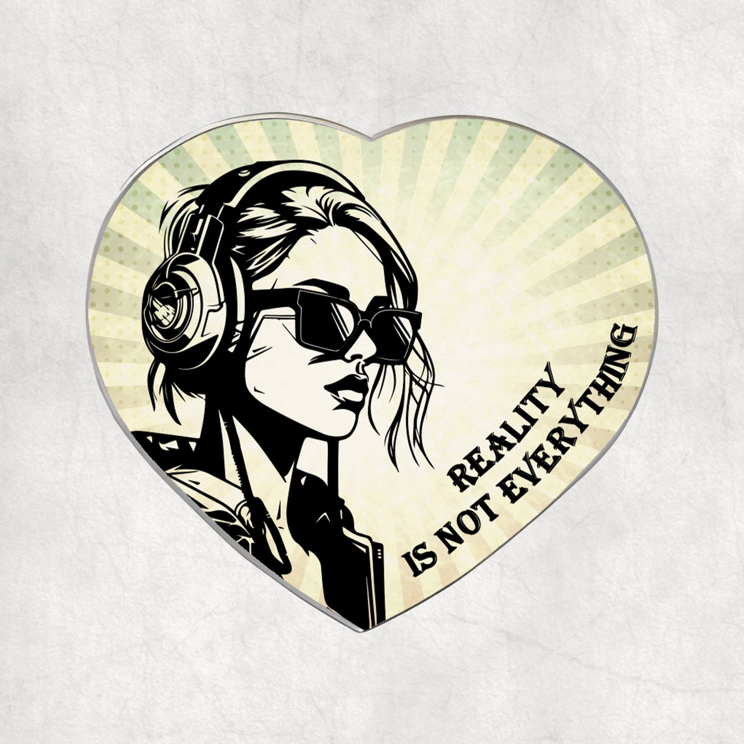 Heart-shaped metal magnet with a stylised illustration of a woman wearing headphones and sunglasses, and the text 'Reality is not everything' on a light vintage background.