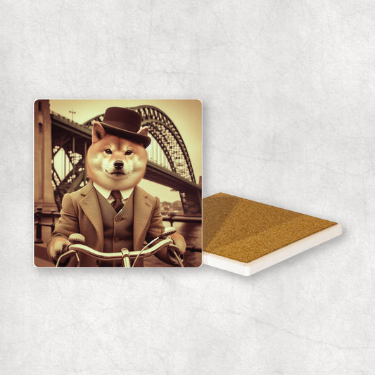 Ceramic coaster with a Shiba Inu dog design, dressed in a suit, riding a bike with a Bridge in the background.
