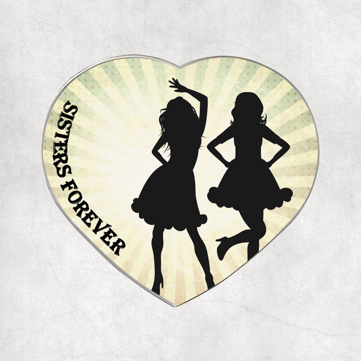 Heart-shaped metal magnet with silhouettes of two girls dancing and 'SISTERS FOREVER' text on a light vintage background.