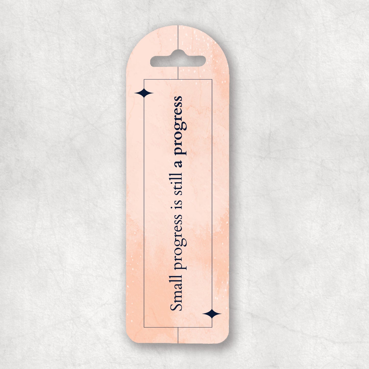Inspiring bookmark with 'Small progress is still a progress' text on a light pink background, the perfect gift for any occasion. 