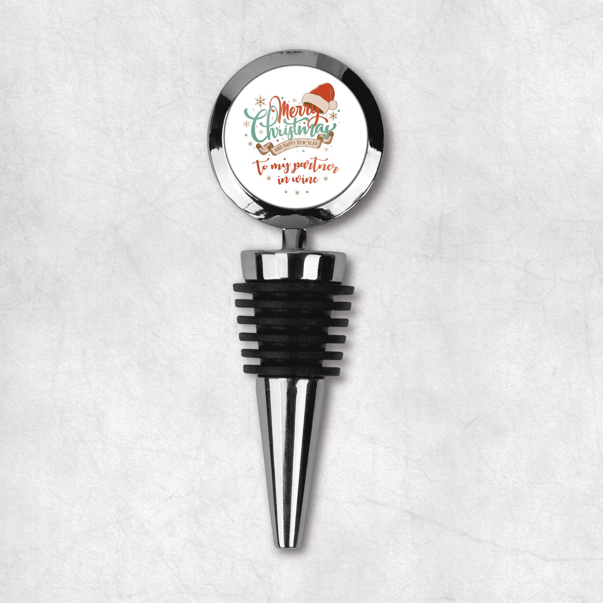 Christmas wine bottle stopper with funny quote 'Merry Christmas to my partner in wine' on Christmas background.